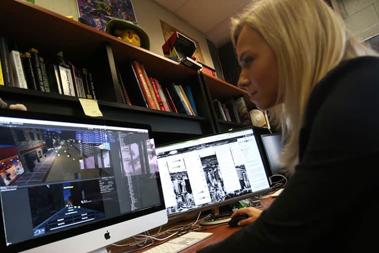 Female graduate student working on a game design in the GEL Lab.