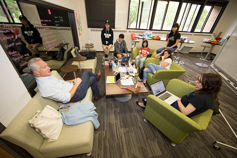 Students discussing project with professor